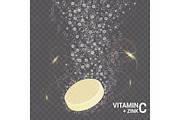 Vitamin C and zink soluble pills with orange flavour in water with sparkling fizzy bubbles trail.