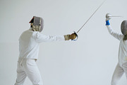 Two fencers have fencing training on white background