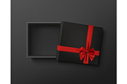 Opened black empty gift box with red ribbon and bow.