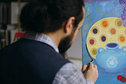 Close-up of Skilled artist man teaching and showing the basics of painting in art studio