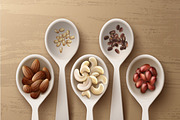 Different nuts in white spoons