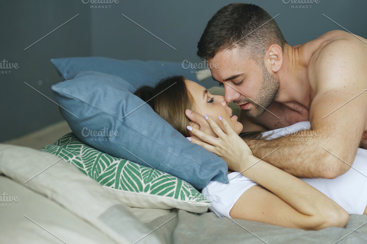 Young beautiful and loving couple kissing on bed in the morning in Graphics - product preview 8