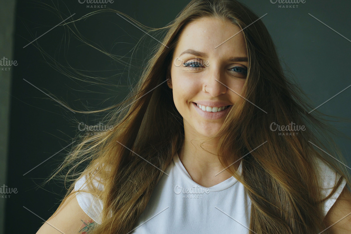 Portrait of young smiling woman with hair flying of wind in Graphics - product preview 8
