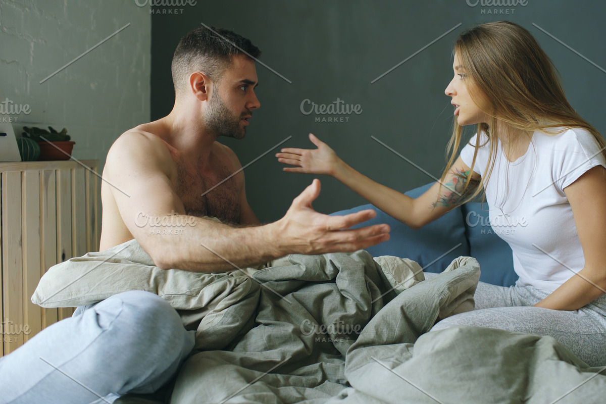 Upset young couple in sitting in bed upset and argue each other in Graphics - product preview 8