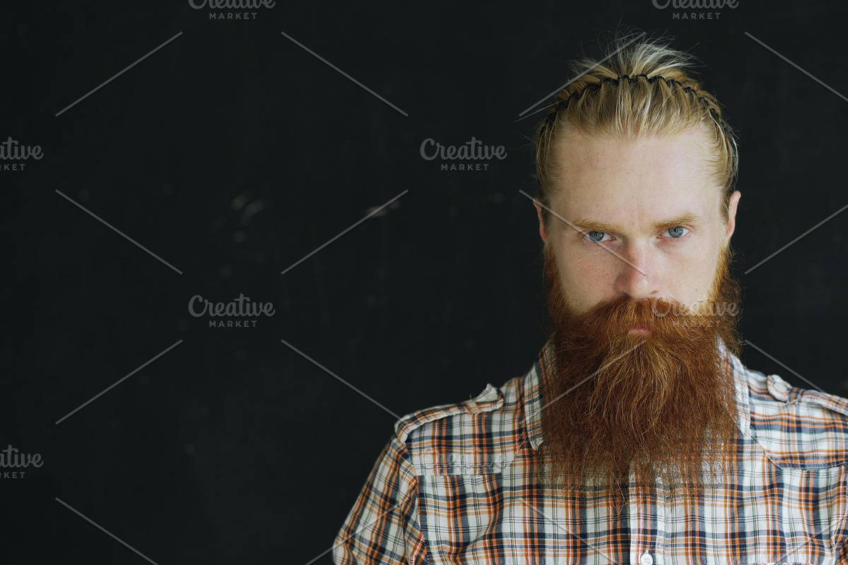 Closeup portrait of young hipster man looking at camera on black background in Graphics - product preview 8