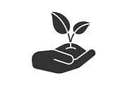 Open hand with sprout glyph icon