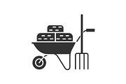 Wheelbarrow with bales of hay and pitchfork glyph icon