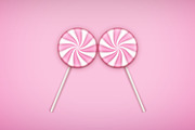 Two Pink Lolipops candy on pastel pink background.