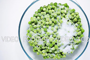 Time-lapse defrost green peas view from above