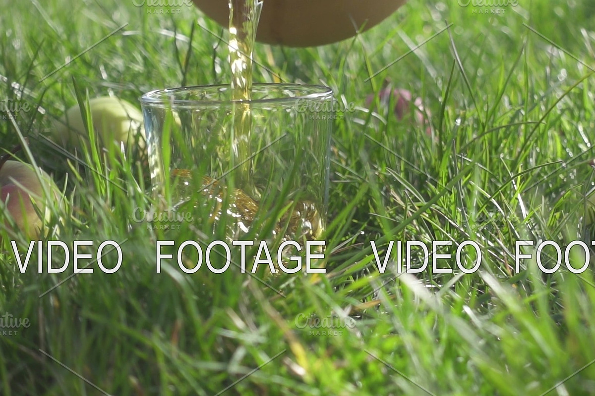 Slow motion in the glass on the grass pours the juice in Graphics - product preview 8