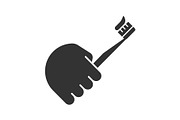Hand holding toothbrush glyph icon