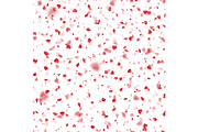Valentines Day background of red hearts petals falling on white background.