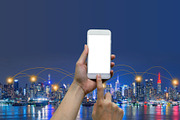 Hands touching smartphone in front of New York City background, social nets and network concept illustration