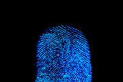 Blue fingerprint identification symbol isolated on black background in technology concept