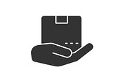 Open hand with parcel glyph icon