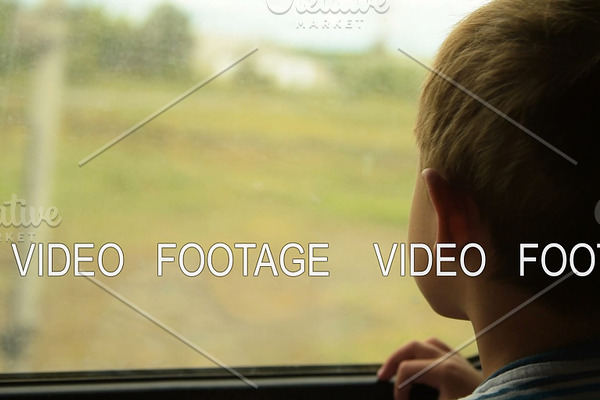 Boy looking out the window of moving train