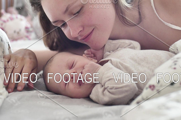 beautiful young mother smile and kiss her newborn child