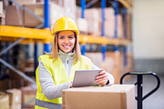 Woman warehouse worker with tablet.