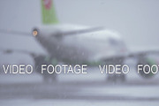 Blur of airplane driving on the landing strip, view in snowfall