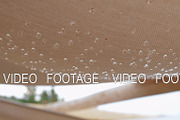 Textile shed with falling raindrops