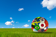 Soccer football with country flags isolated on lush grass and blue sky. World championship. 3d illustration.
