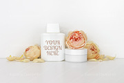 Cosmetics mockup with roses, bottle