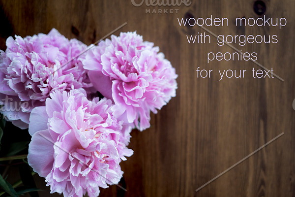 Peonies flowers at wooden background