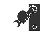 Hand holding wrench glyph icon