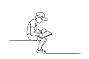 Schoolboy sitting with book