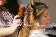 Hairdresser woman dries the hair