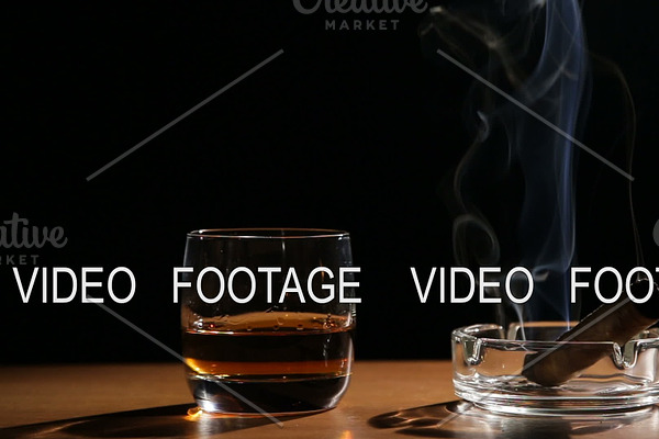 Whiskey drinks with smoking cigars
