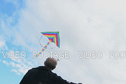 Senior man flying kite, view against