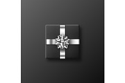 Black gift box with metallic bow and