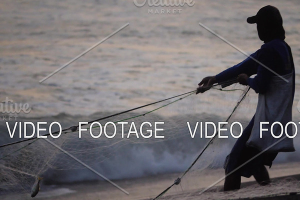 fisherman pulls net out ofocean