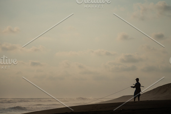 fisherman pulls net out ofocean