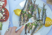 Eating appetizing sardines dish