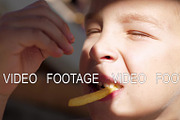 Kid eating fries outdoor