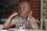 Kid eating chocolate ice cream