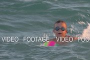 Child bathing in the sea and