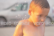 Child taking outdoor beach shower
