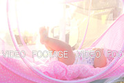 Baby girl in pink bassinet outdoor