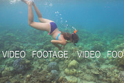 Girl snorkelling underwater.