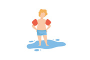 Cute Boy Standing in Water Wearing