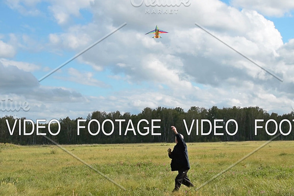 Active senior man flying kite