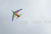 Rainbow kite flying against cloudy