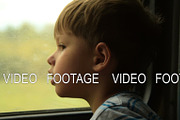 Kid looking through the train window