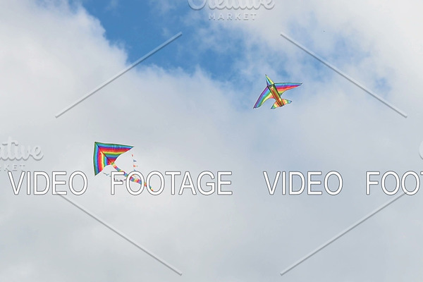 Flying kites in cloudy sky