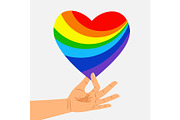Human hand hold rainbow heart. LGBT