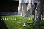 Wedding dress and shoes hanging on a