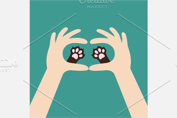 Two hands holding cat dog paw print.